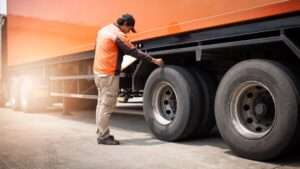 Auto mechanic checking a truck wheels tires truck inspection maintenance safety driving Auto mechanic checking a truck wheels tires truck inspection maintenance safety driving