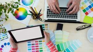 Hands of graphic designers using laptop and digital tablet