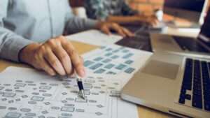 software-developer-is-pointing-to-the-paper-workin-min software-developer-is-pointing-to-the-paper-workin-min