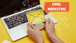cropped image of woman holding envelope sign near laptop with”email marketing” lettering and email cropped image of woman holding envelope sign near laptop with"email marketing" lettering and email