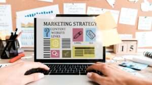 cropped view of woman using laptop with marketing strategy lettering on screen near sticky notes cropped view of woman using laptop with marketing strategy lettering on screen near sticky notes