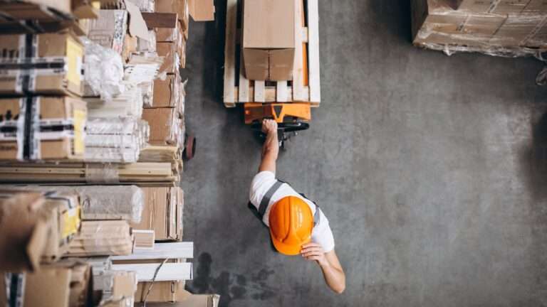 Young man working at a warehouse with boxes